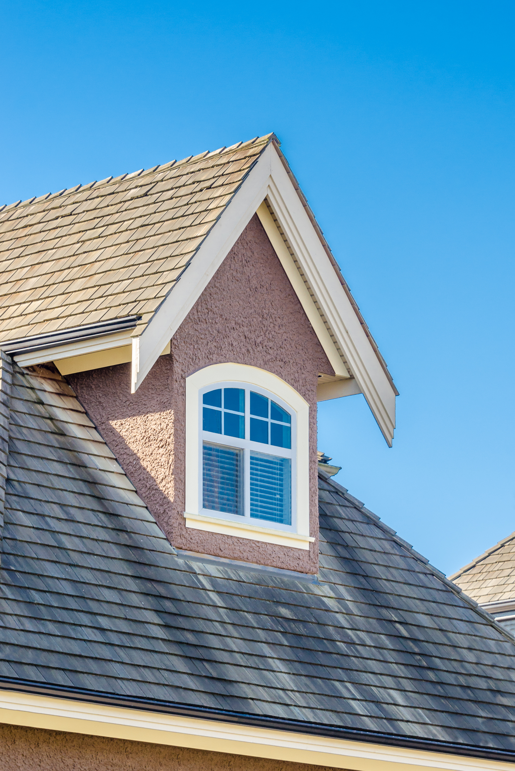 house-dormer-with-an-arched-window-under-blue-sky-2026-03-26-11-34-47-utc